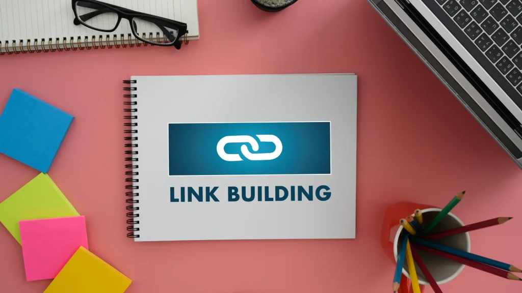 A notebook with "Link Building" highlighted, emphasizing strategies for second-tier link building in SEO.