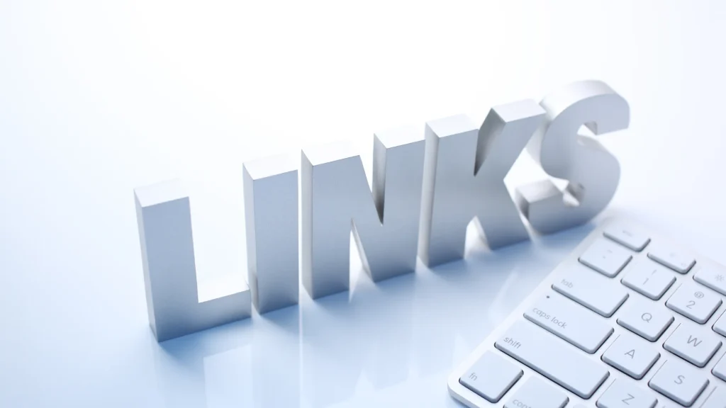 BuildingLink concept with large 3D text 'LINKS' placed beside a computer keyboard, symbolizing online connectivity and digital networking.